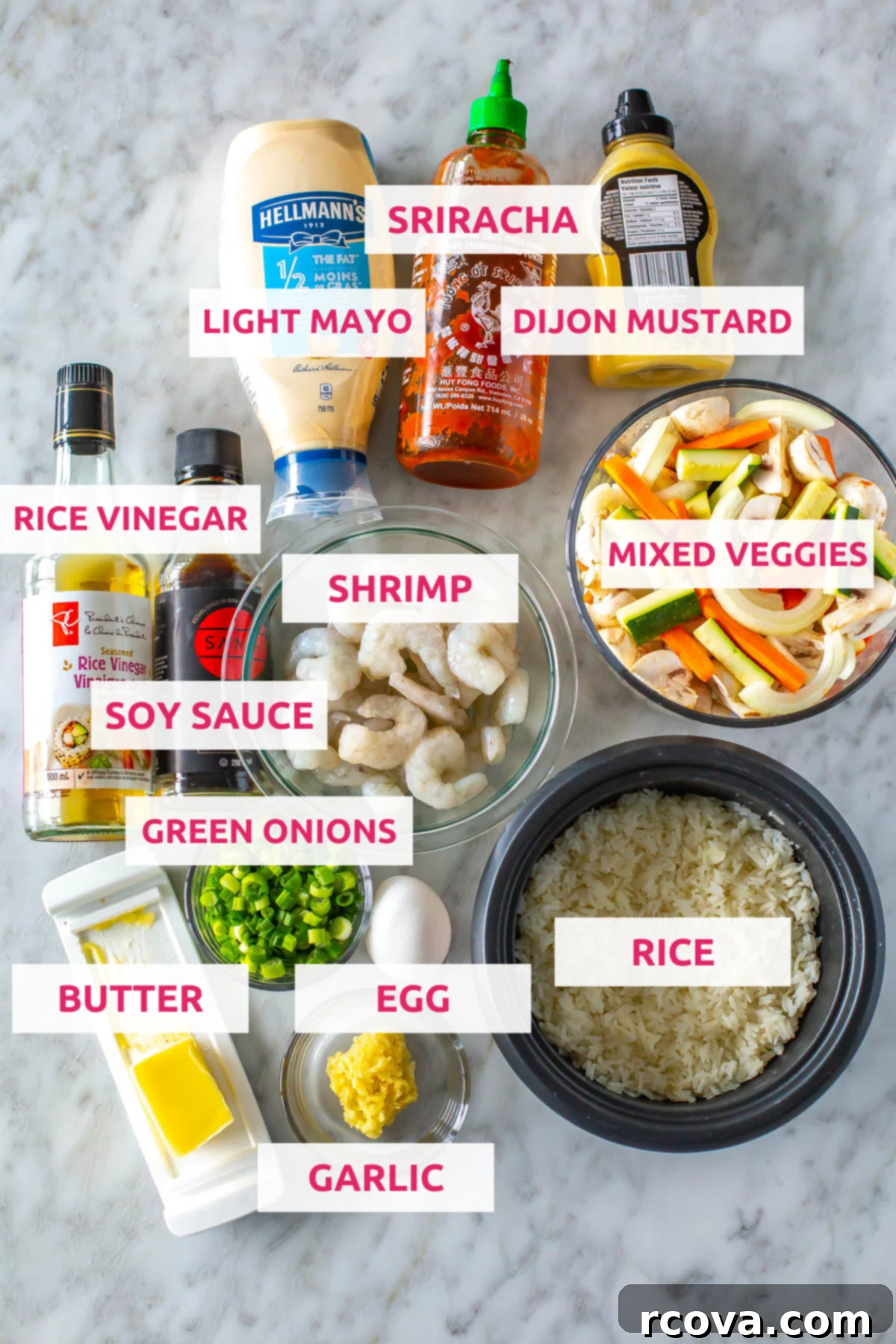 Perfect Benihana Style Hibachi Shrimp 4 A vibrant flat lay of all the fresh ingredients needed for homemade hibachi shrimp: light mayo, sriracha, dijon mustard, rice vinegar, soy sauce, raw shrimp, assorted mixed vegetables (mushrooms, carrots, onion, zucchini), butter, green onion, an egg, cooked white rice, and garlic.