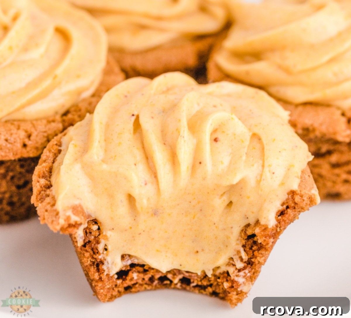Spiced Pumpkin Cheesecake Ginger Delights 3 Close-up of baked pumpkin cheesecake ginger cookies in a muffin tin, showcasing their cup shape.
