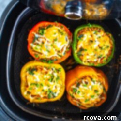 Effortless Air Fryer Stuffed Peppers 11 Four cooked air fryer stuffed peppers in an air fryer.