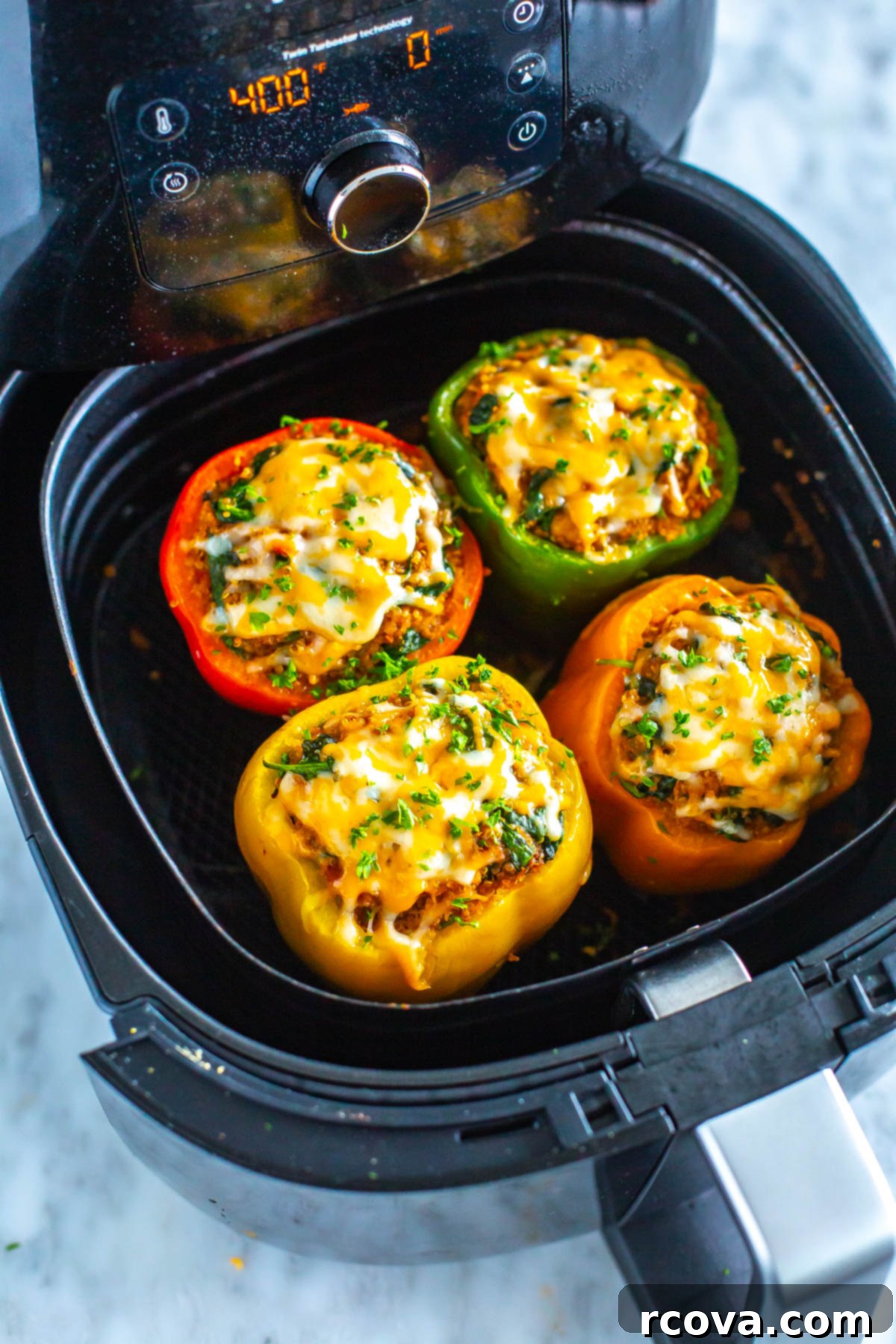 Effortless Air Fryer Stuffed Peppers 9 An air fryer with cooked stuffed peppers inside.