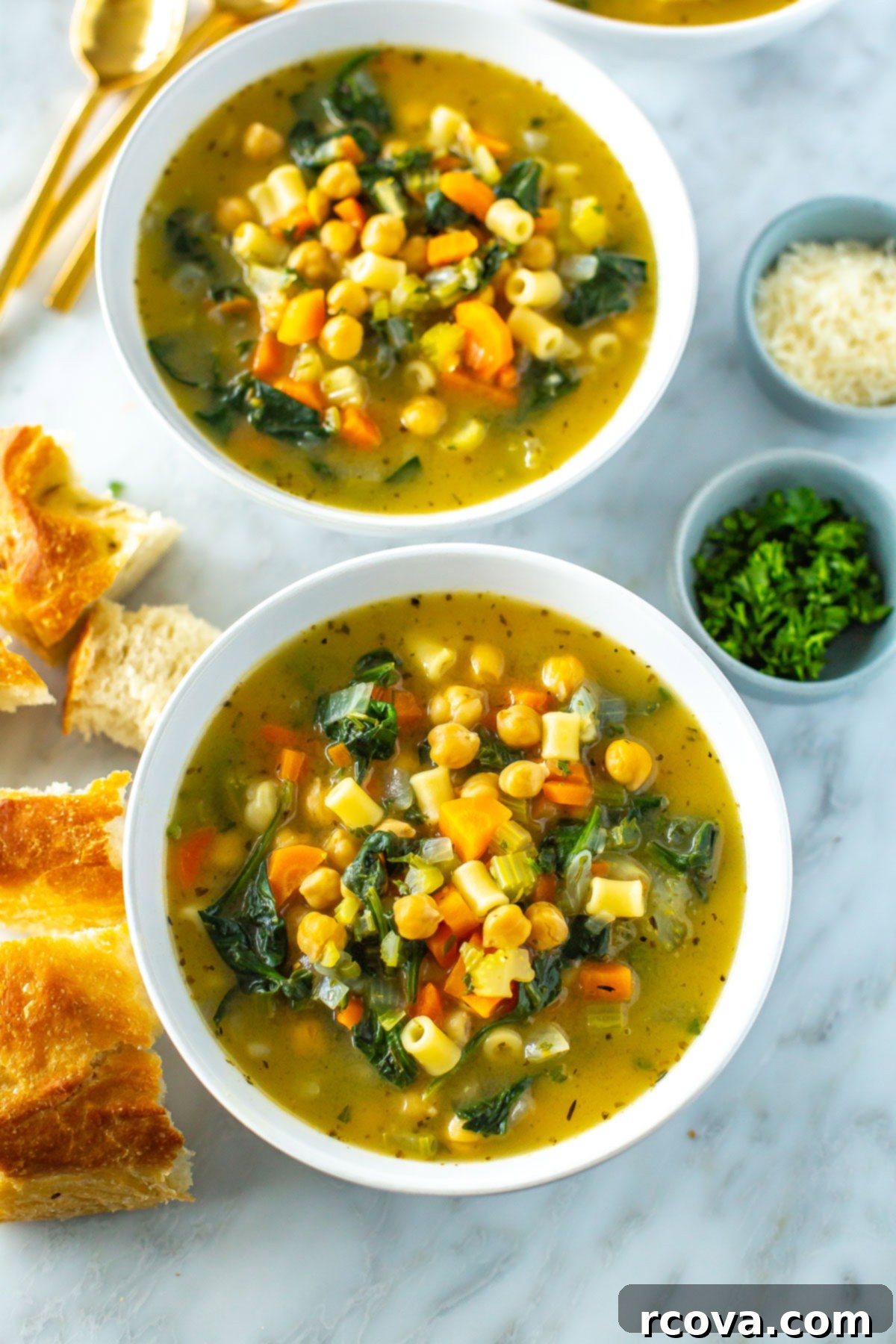 20 No-Fuss Slow Cooker Soup Recipes 16 Two inviting bowls of hearty chickpea soup, garnished with parmesan and served with crusty bread.