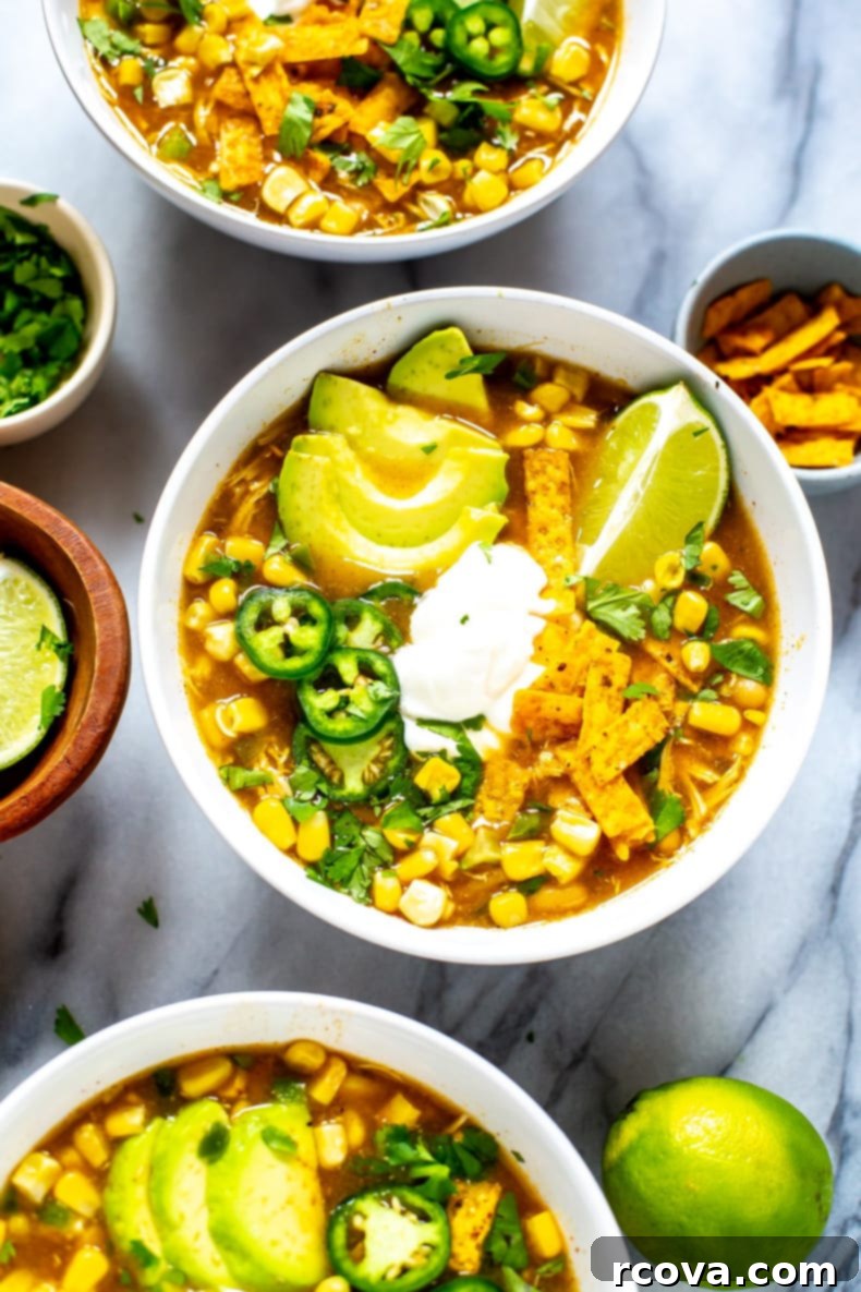 20 No-Fuss Slow Cooker Soup Recipes 20 Creamy Crockpot White Chicken Chili, garnished with fresh cilantro and a dollop of sour cream.