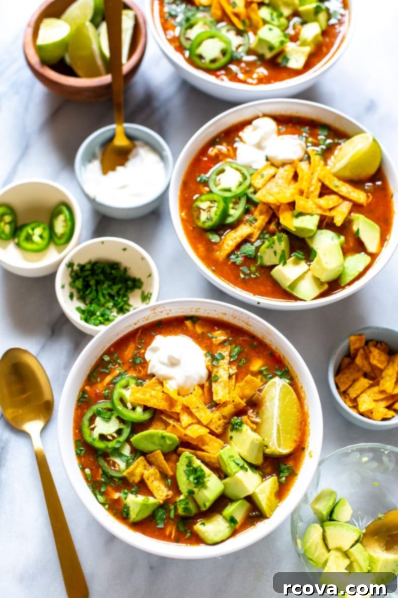 20 No-Fuss Slow Cooker Soup Recipes 5 Vibrant Crockpot Chicken Tortilla Soup topped with fresh avocado and cilantro.