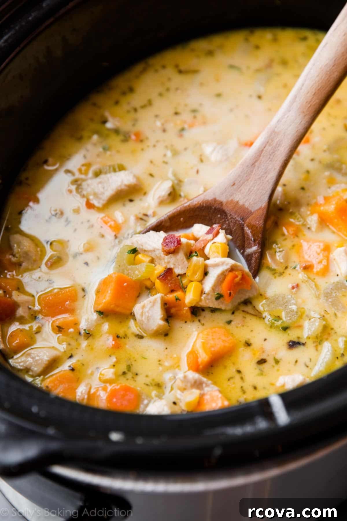 20 No-Fuss Slow Cooker Soup Recipes 6 Creamy chicken and corn soup simmering in a crockpot, ready to serve.
