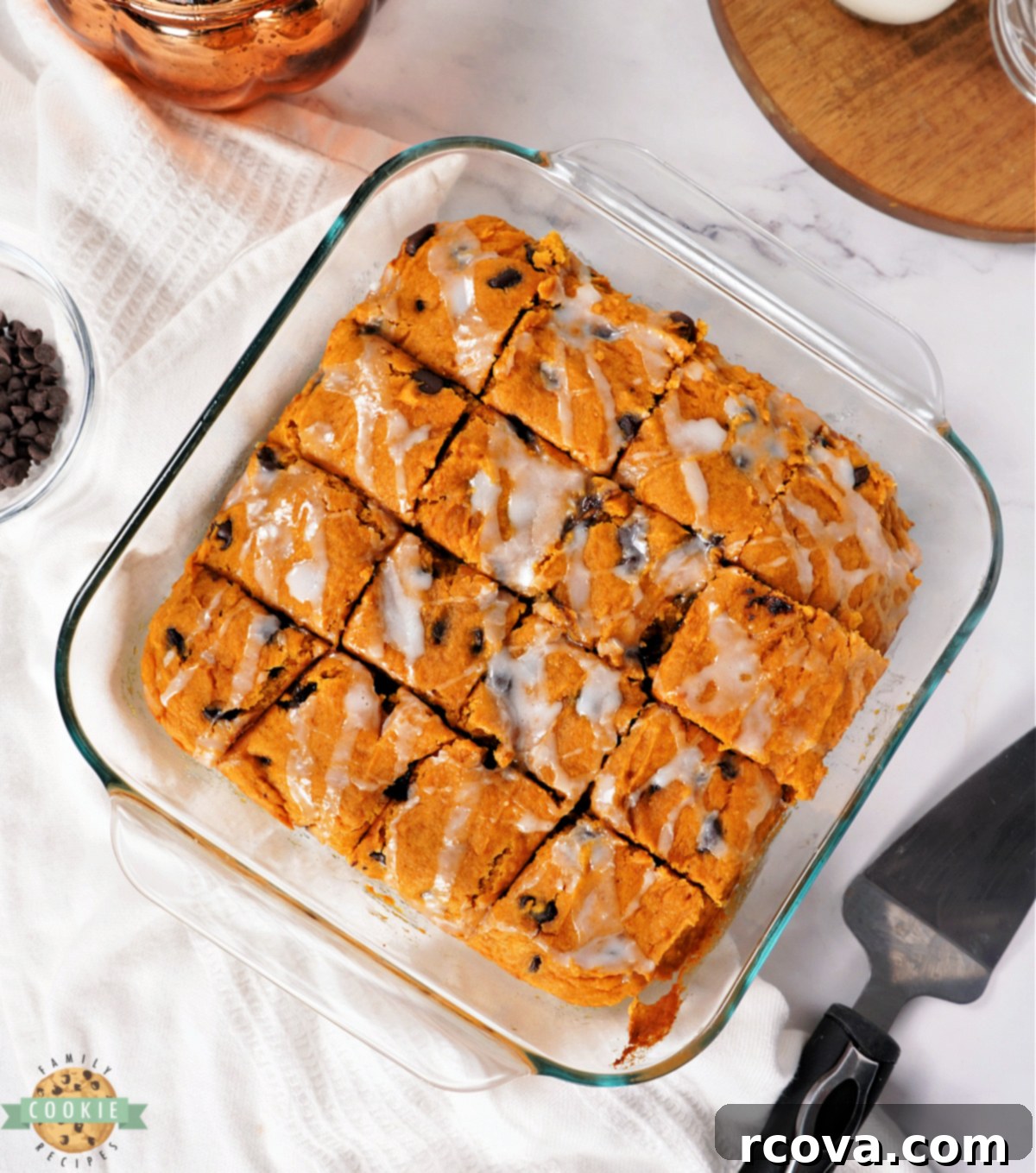 Cozy Autumn Pumpkin Chocolate Chip Bars 2 Square pan of pumpkin bars drizzled with sweet white glaze, ready to be served.