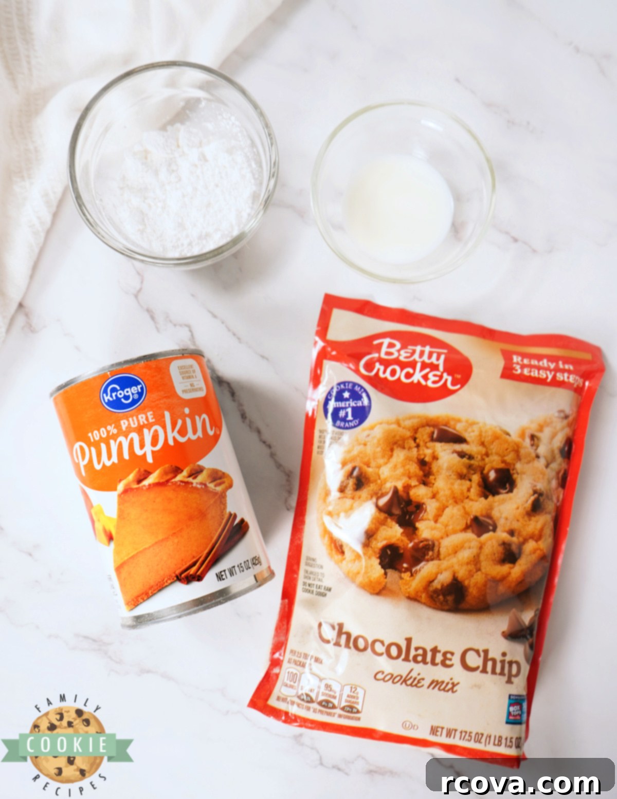Cozy Autumn Pumpkin Chocolate Chip Bars 3 The four simple ingredients laid out for Pumpkin Chocolate Chip Cookie Bars: cookie mix, pumpkin puree, powdered sugar, and milk.