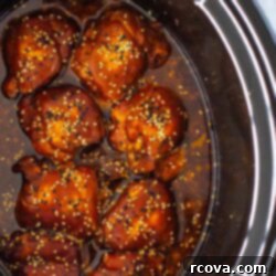 Honey Garlic Slow Cooker Chicken 11 A slow cooker with honey garlic chicken thighs inside.