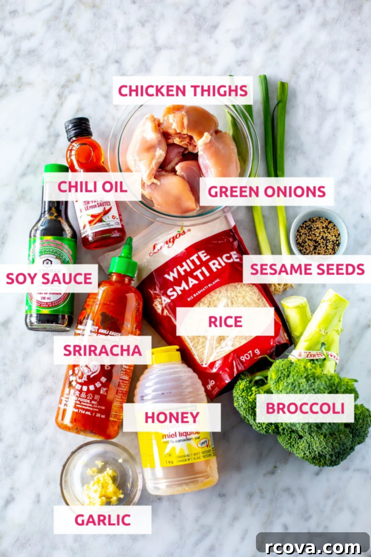 Honey Garlic Slow Cooker Chicken 4 Ingredients for slow cooker honey garlic chicken thighs: chicken thighs, green onions, sesame seeds, broccoli, sriracha, minced garlic, honey, chili oil, and low-sodium soy sauce laid out on a kitchen counter.