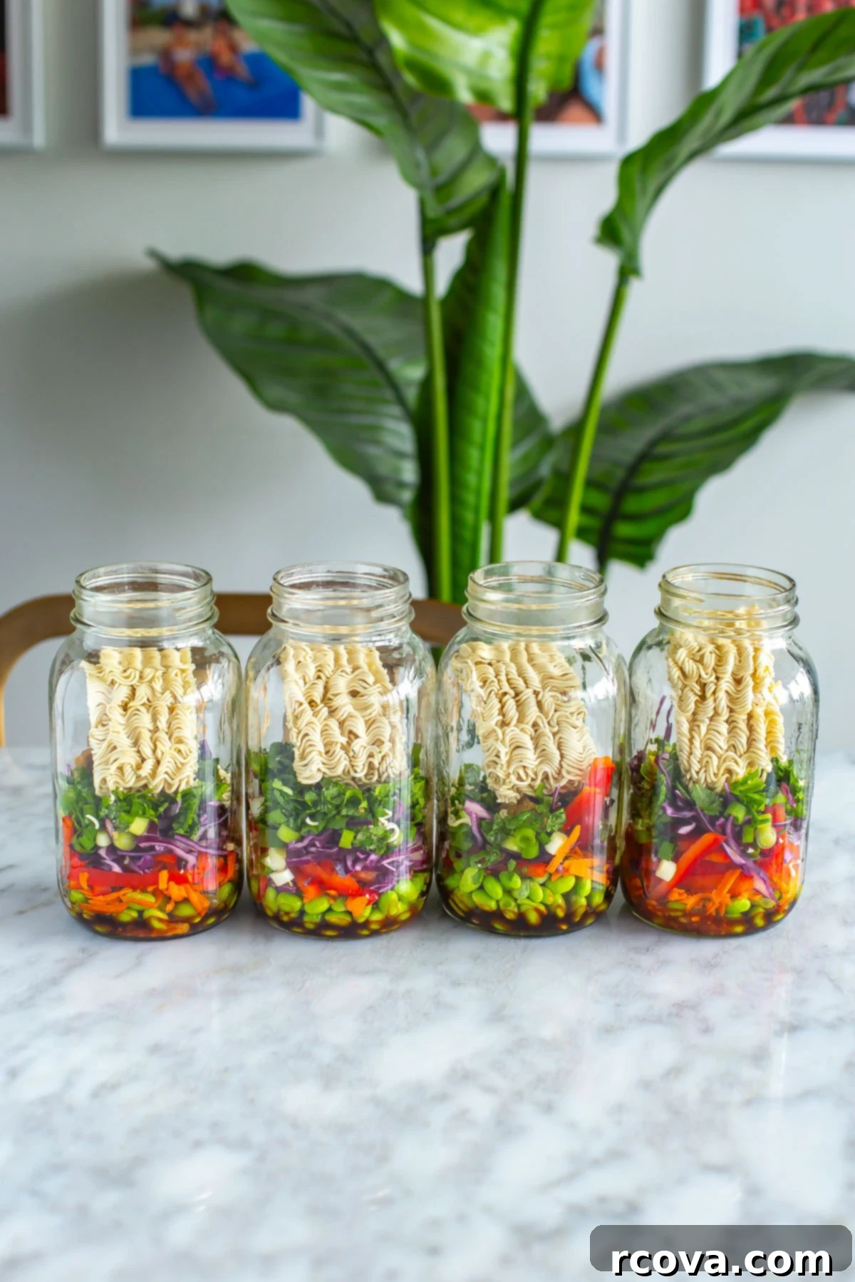 Homemade Instant Noodle Perfection 9 Four beautifully layered mason jars, each filled with wholesome instant noodles, a variety of fresh vegetables, and aromatic herbs, showcasing a vibrant and healthy meal prep.