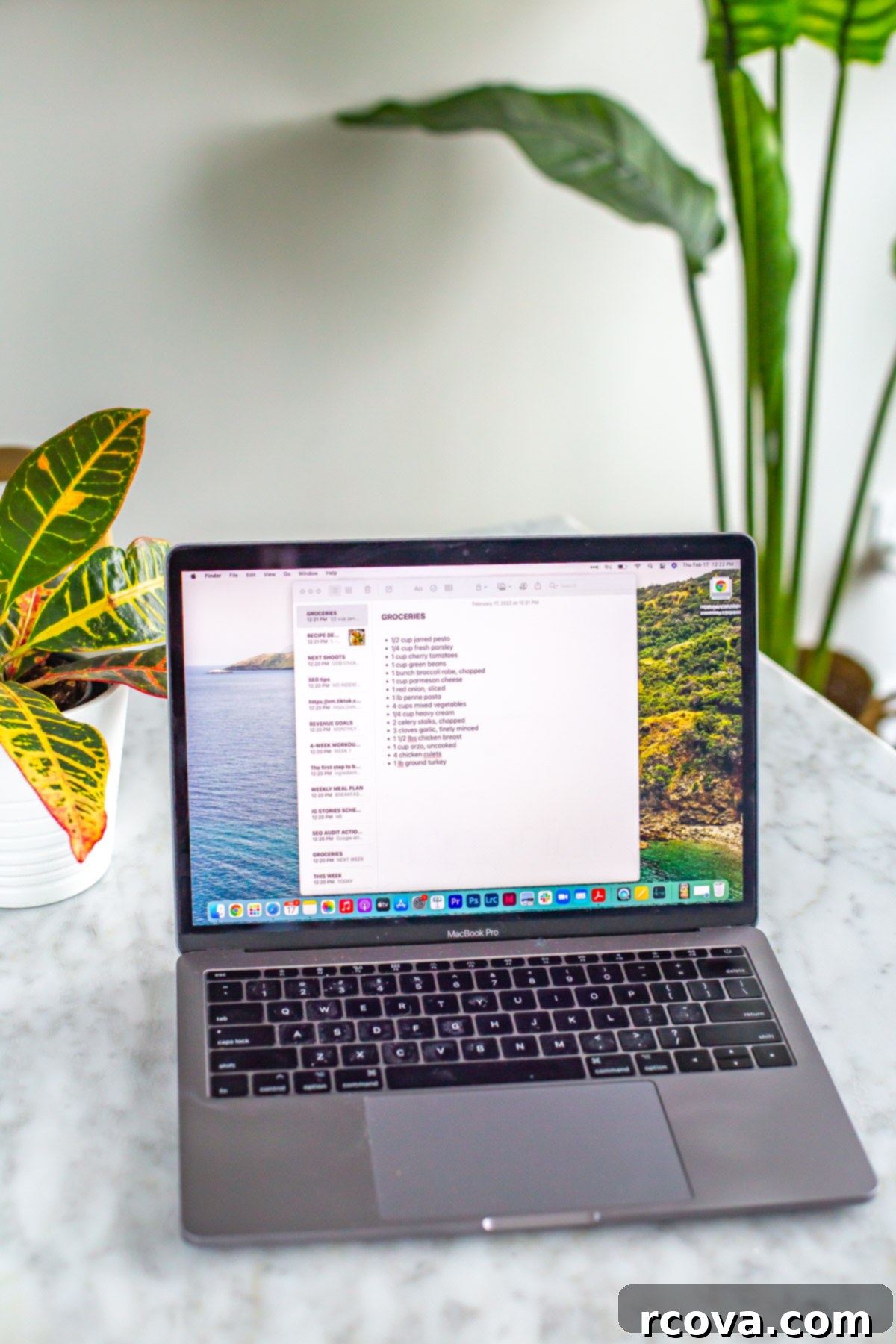 8 Clever Tricks to Cut Food Waste and Boost Your Savings 4 Image of a laptop with a grocery list appearing in a note document on the computer, symbolizing organized shopping and meal preparation.