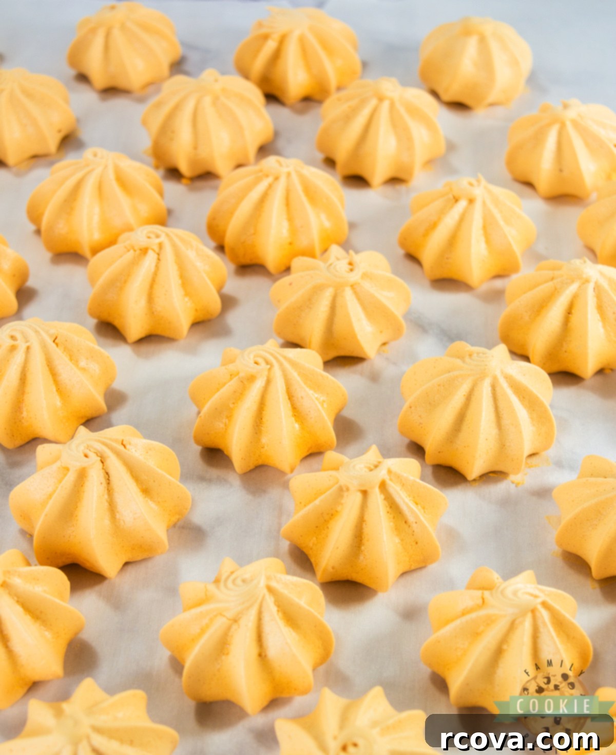 Pumpkin Spice Meringue Clouds 7 A baking sheet filled with perfectly baked, bright orange pumpkin meringues cooling down slowly on parchment paper.