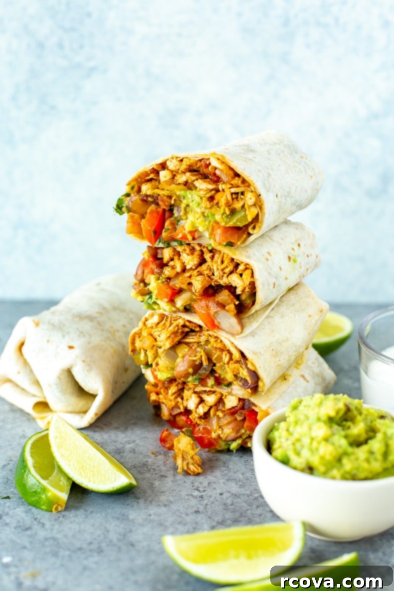 Quick Chicken Burrito Meal 8 A beautifully presented Pulled Chicken Burrito, cut in half to reveal its delicious layers, ready to be eaten.