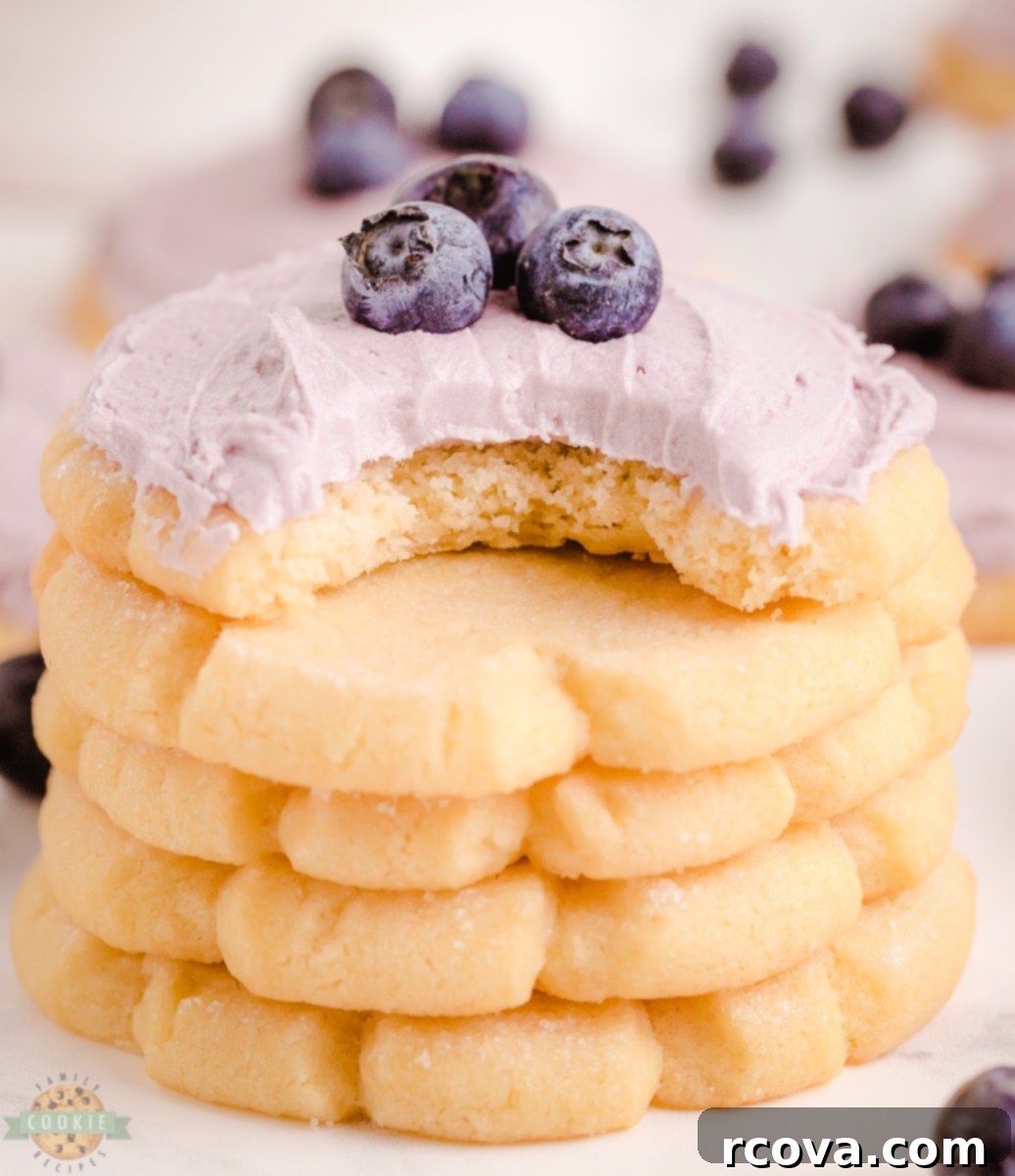 Signature Rough-Edge Blueberry Sugar Cookie Close-up view of a single blueberry sugar cookie with thick blueberry frosting and rough edges.
