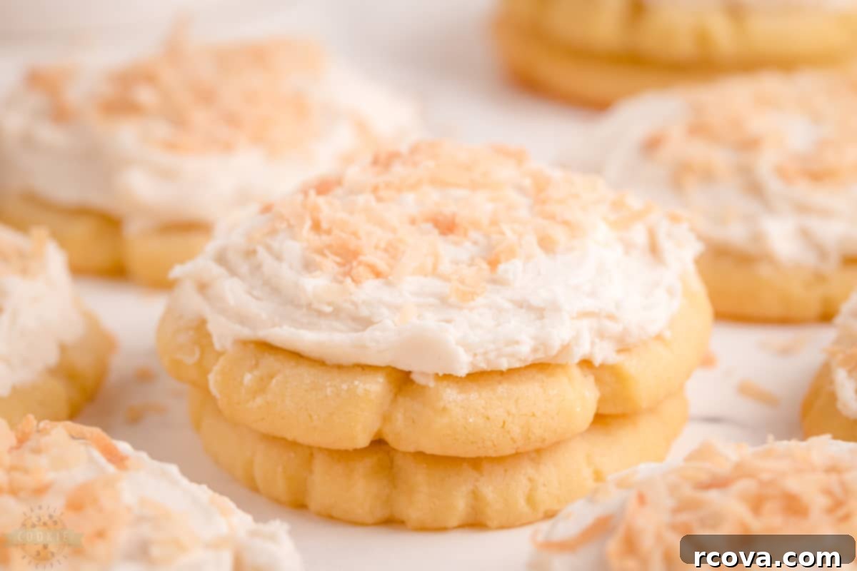 Tropical Coconut Cookies 2 Frosted Coconut Sugar Cookies on a white plate
