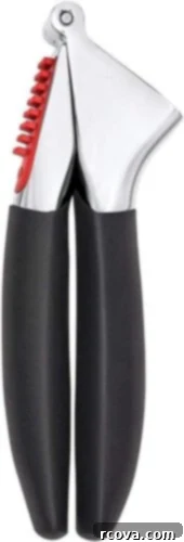 Ultimate Kitchen Setup 17 A garlic press with black handles, for quickly mincing garlic.