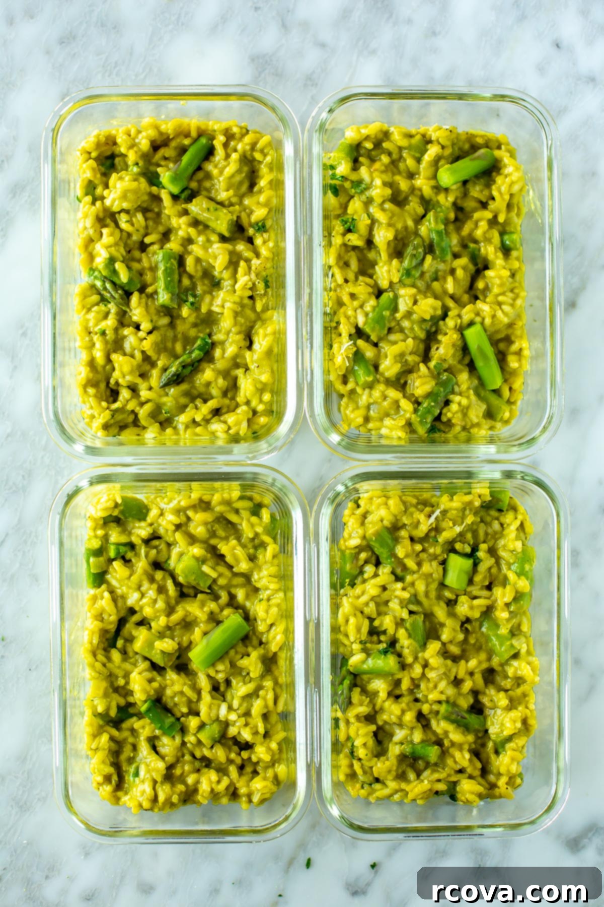Velvety Asparagus Risotto 11 Four glass meal prep containers, each perfectly portioned with creamy asparagus risotto, ideal for future meals.