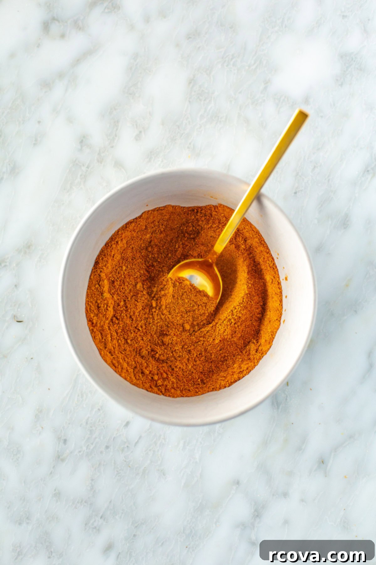 Foolproof Shawarma Spice Mix 6 Homemade shawarma seasoning beautifully mixed in a bowl with a small spoon, highlighting its texture and color
