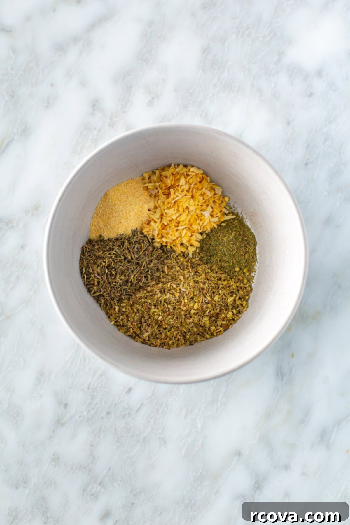 Effortless Greek Spice Blend 2 Bowl of various spices forming the homemade Greek seasoning, ready to be mixed