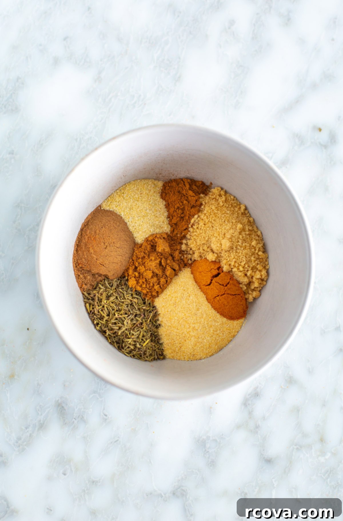 Quick & Flavorful Homemade Jerk Seasoning 2 Bowl of richly colored spices making up the homemade Jerk Seasoning blend, ready to be mixed.
