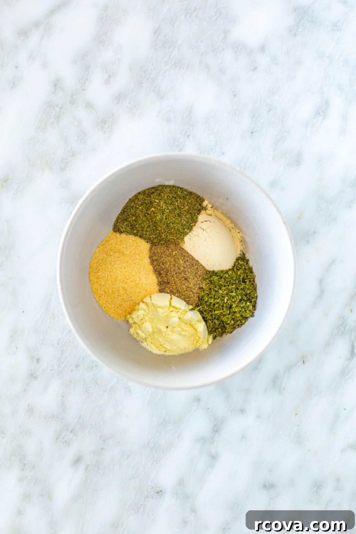 Foolproof Homemade Ranch Mix 2 A bowl filled with a fresh batch of homemade ranch seasoning, showing the various dried herbs and spices beautifully mixed together.