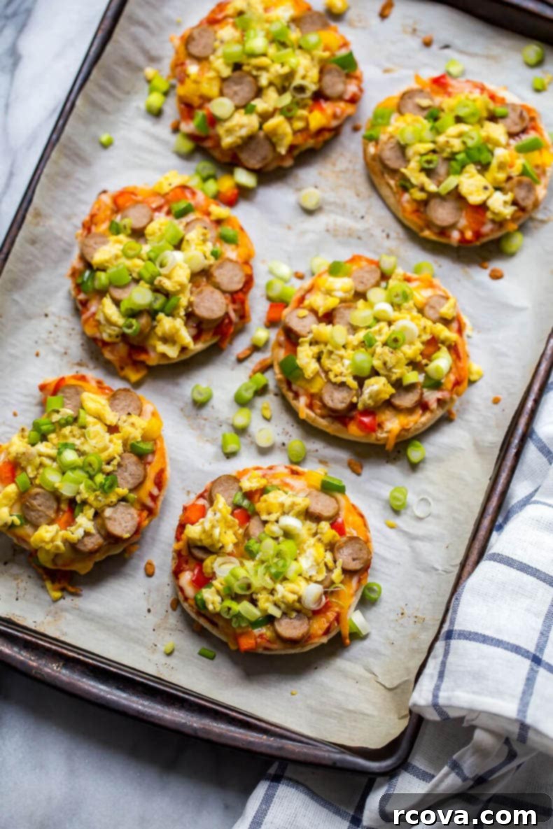 35+ Healthy and Easy Recipes Under 500 Calories 15 Appetizing Freezer-Friendly Mini Breakfast Pizzas, topped with turkey sausage and egg, ideal for a quick and satisfying meal.