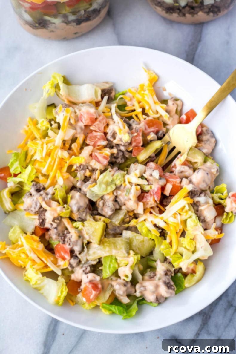 35+ Healthy and Easy Recipes Under 500 Calories 23 Layered Meal Prep Low Carb Big Mac Salad Jars, a healthy twist on the classic cheeseburger, perfect for on-the-go lunches.