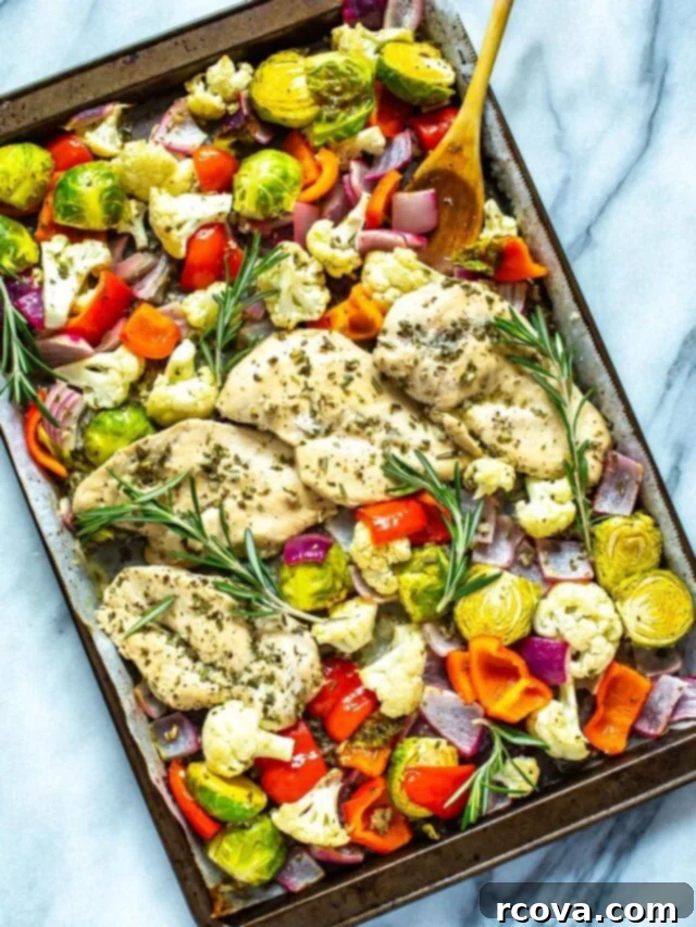 35+ Healthy and Easy Recipes Under 500 Calories 32 A close-up of a perfectly cooked Sheet Pan Rosemary Chicken, showcasing its golden-brown skin and aromatic herbs.