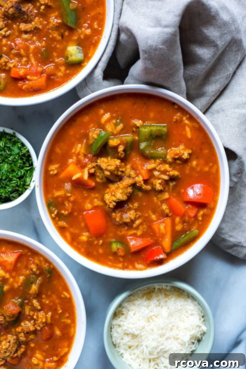 35+ Healthy and Easy Recipes Under 500 Calories 41 A hearty bowl of Instant Pot Stuffed Pepper Soup, rich with marinara sauce, ground chicken, rice, and colorful peppers.