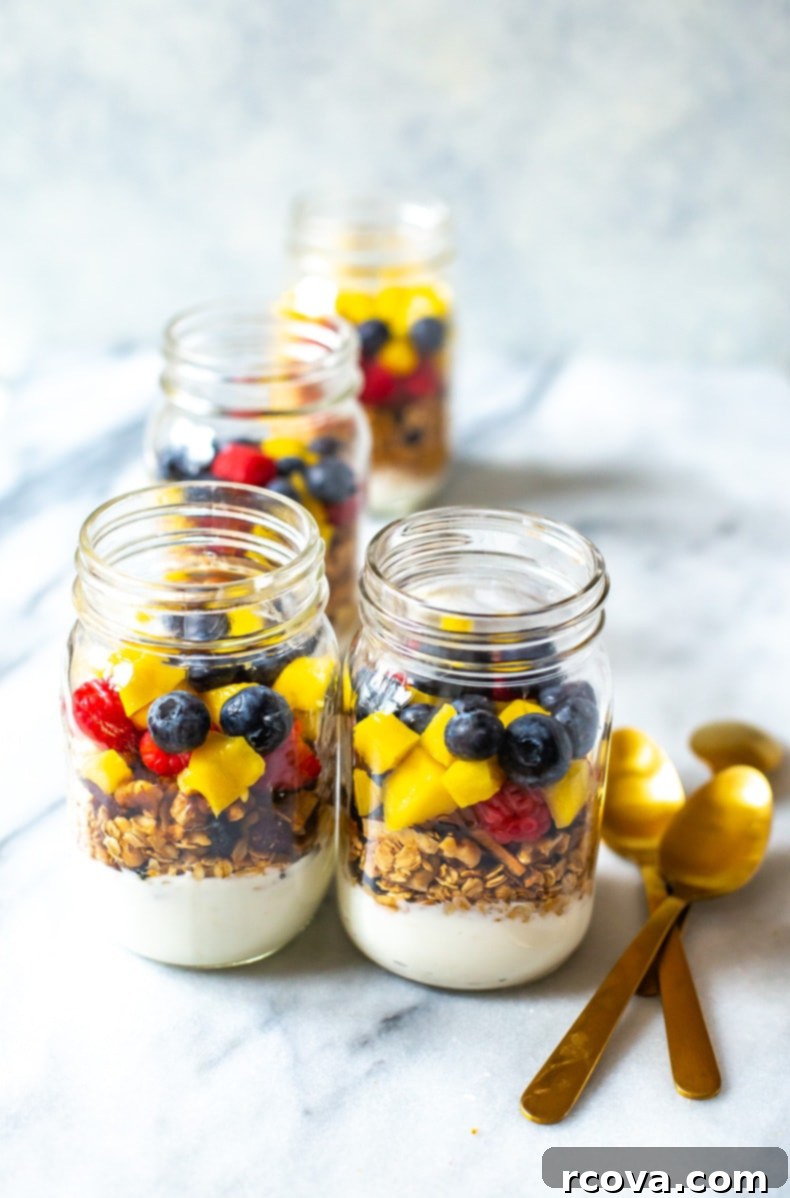 35+ Healthy and Easy Recipes Under 500 Calories 8 Visually appealing Meal Prep Yogurt Parfaits layered in clear jars, showcasing vibrant fresh fruit, creamy yogurt, and crunchy granola.