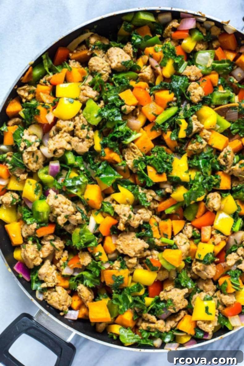 35+ Healthy and Easy Recipes Under 500 Calories 9 A hearty and colorful Meal Prep Whole 30 Sweet Potato Hash, bursting with savory ingredients and fresh herbs.