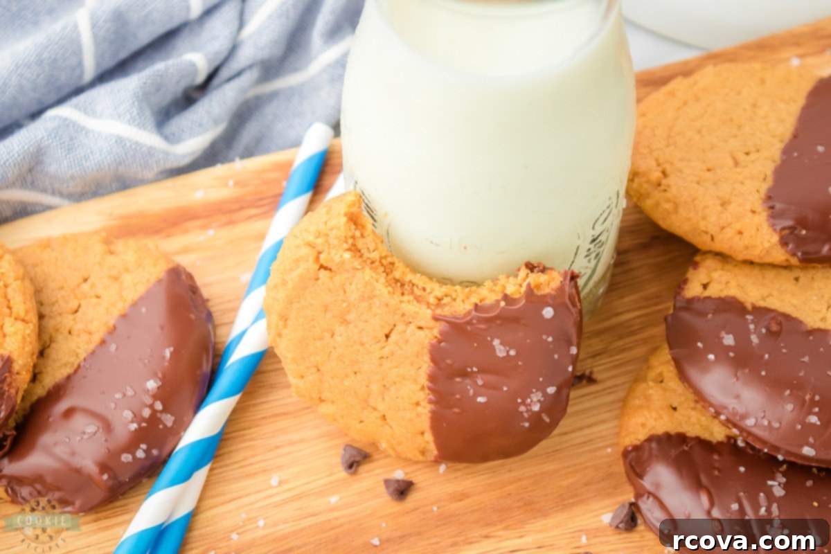 Irresistibly Chewy Peanut Butter Bliss 8 Several chocolate-dipped peanut butter cookies on a cooling rack.
