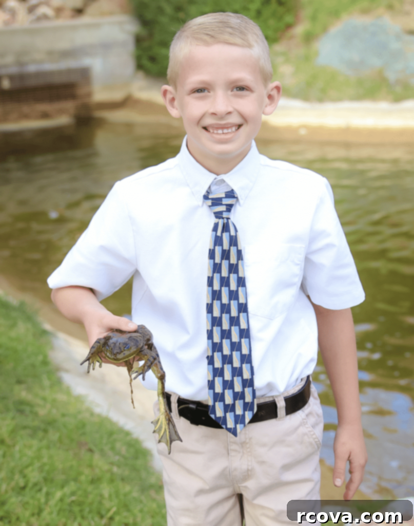 Tricolor Vanilla Delights 9 A young boy in a button-up shirt and tie, holding a frog, with a genuine smile