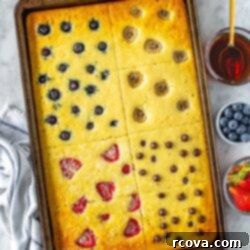 Sheet Pan Pancakes 4 Ways 11 Sheet pan pancakes with various toppings baked in them, ready to be served.