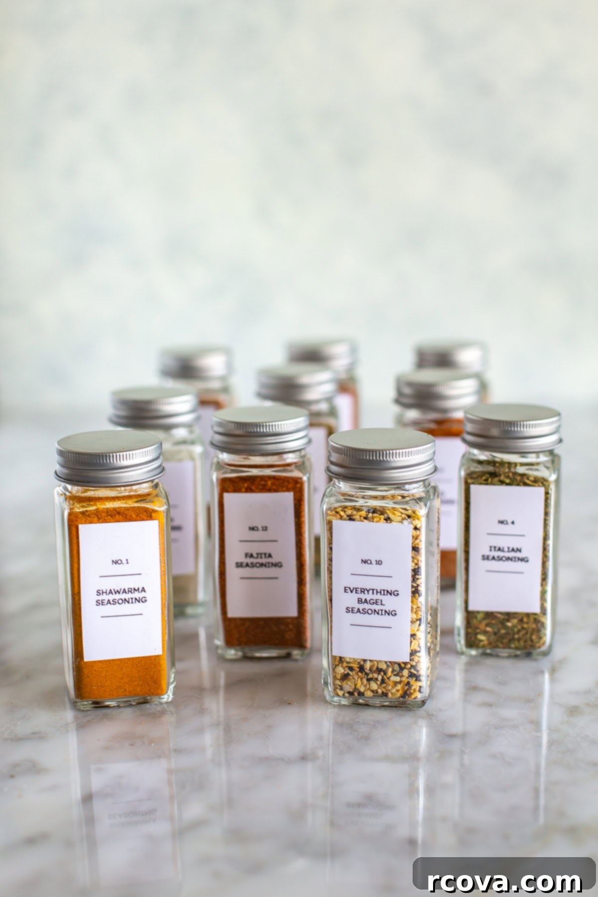 The Ultimate Healthy Pantry Checklist 5 A selection of homemade spice blends neatly arranged in clear glass jars, demonstrating organized spice storage.