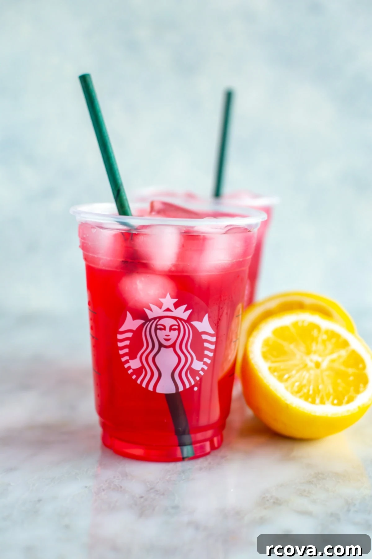 Make Your Own Starbucks Summer Drinks At Home 12 A cup of homemade Starbucks passion tea lemonade, garnished with a lemon slice.