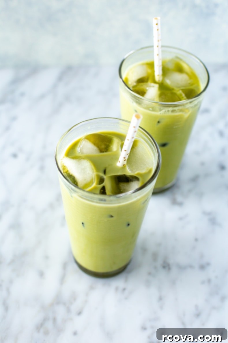 Make Your Own Starbucks Summer Drinks At Home 13 A glass of homemade Starbucks Iced Matcha Latte, showing its vibrant green color.
