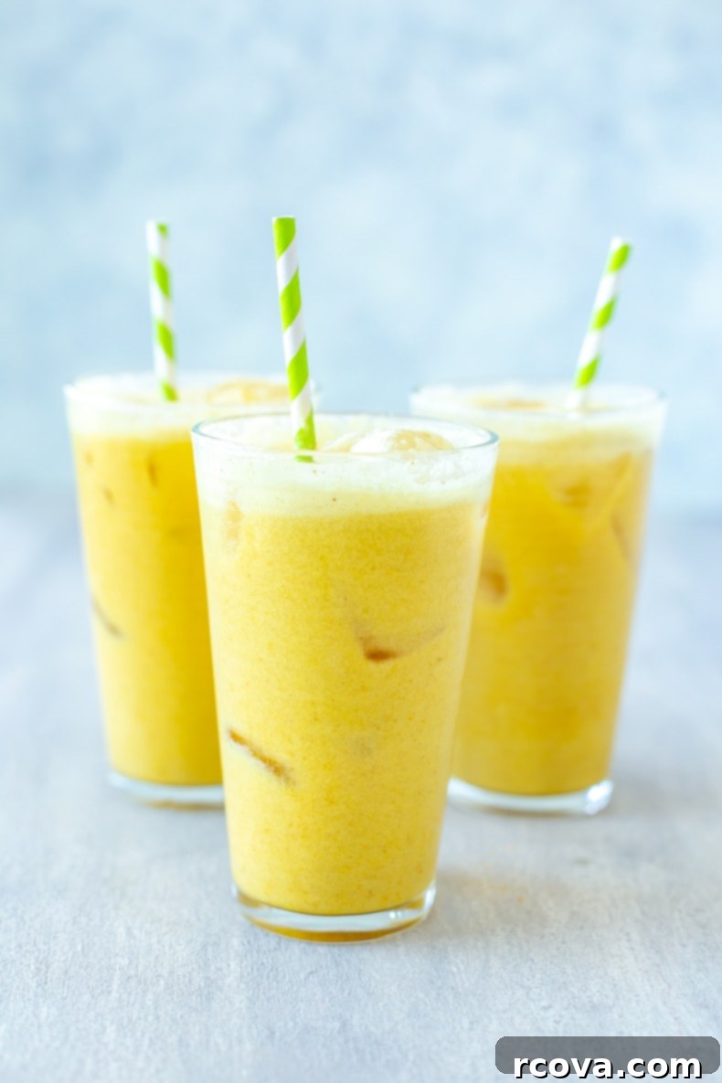 Make Your Own Starbucks Summer Drinks At Home 14 A glass of homemade Iced Golden Ginger Drink, showing its warm golden hue.
