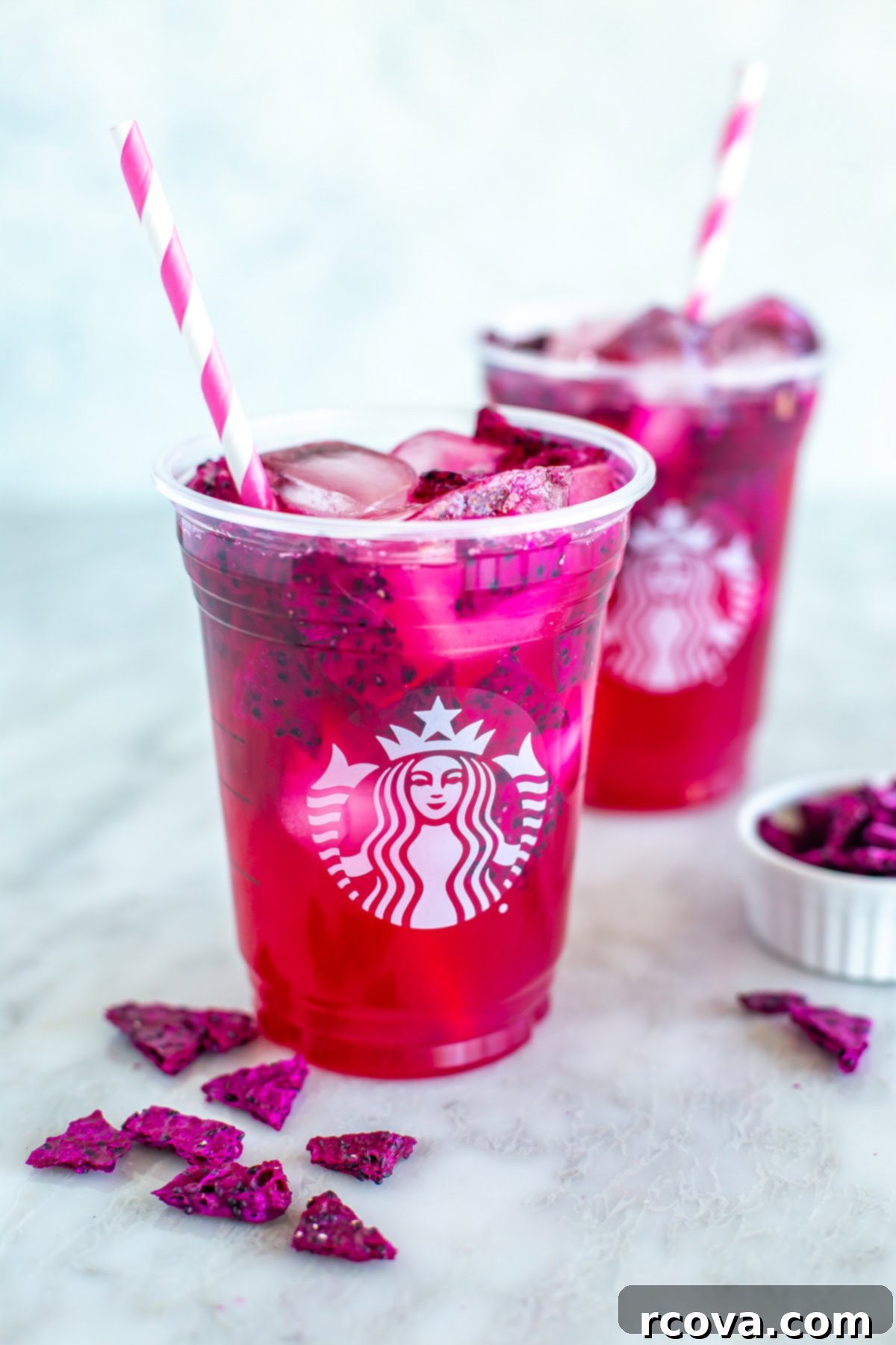 Make Your Own Starbucks Summer Drinks At Home 5 Two homemade Starbucks mango dragonfruit refreshers, garnished with fresh dragonfruit slices.