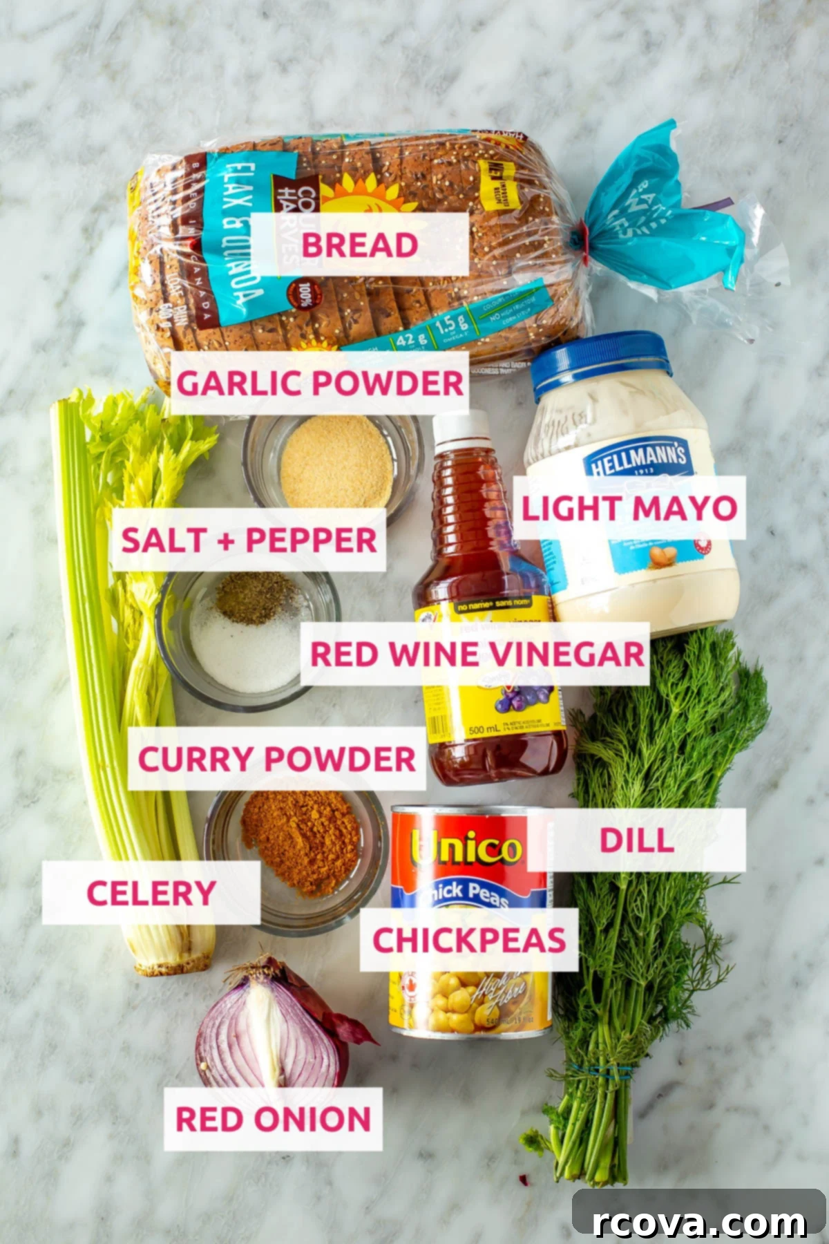 Chickpea Tuna Salad Sandwich: A Vegetarian Delight 4 Ingredients for chickpea tuna salad sandwich: whole wheat bread, chickpeas, salt, pepper, fresh dill, diced celery, curry powder, garlic powder, red onion, light mayo, and red wine vinegar arranged on a wooden board.