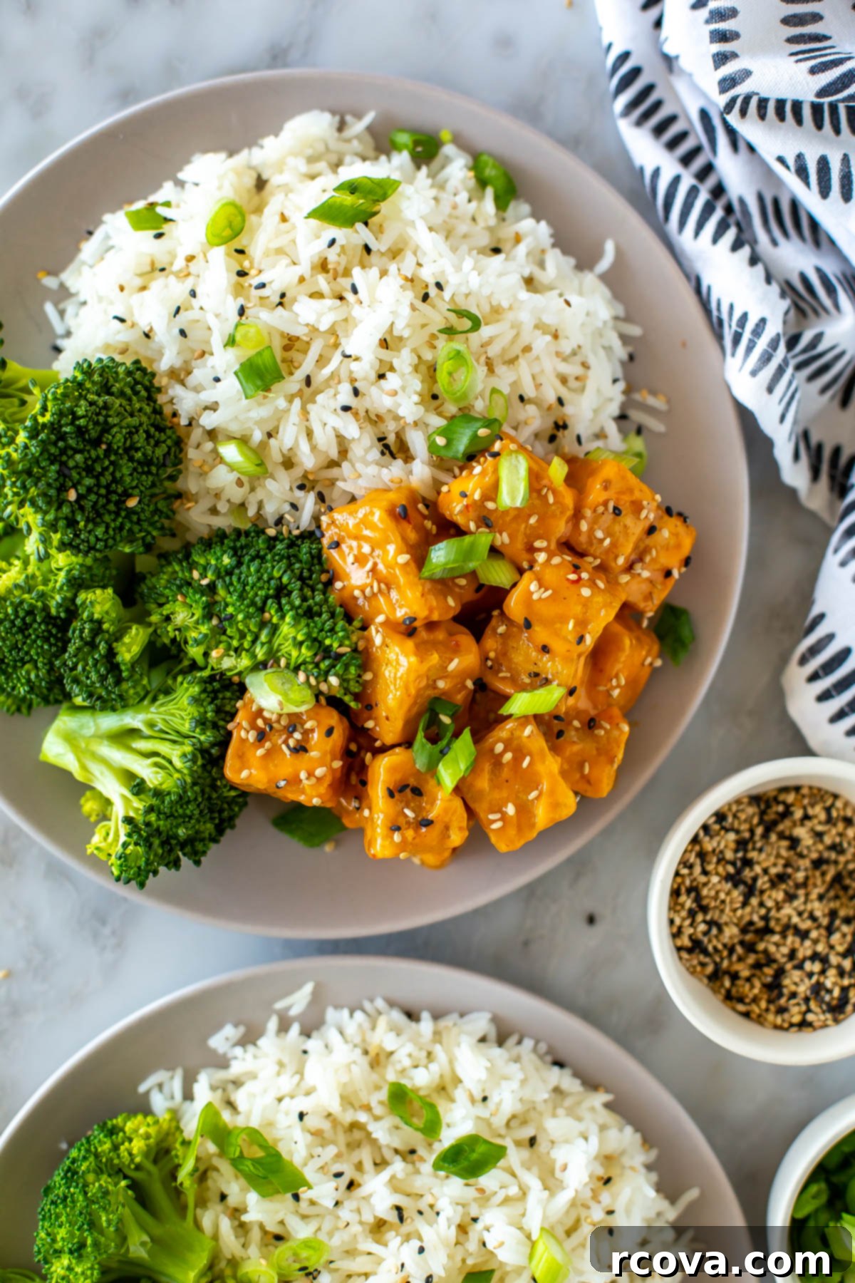 Master Crispy Air Fryer Tofu with Our Ultimate Sauce 8 A close-up of a perfectly plated dish of air fryer tofu, rice, and broccoli, showing the crispy texture of the tofu.