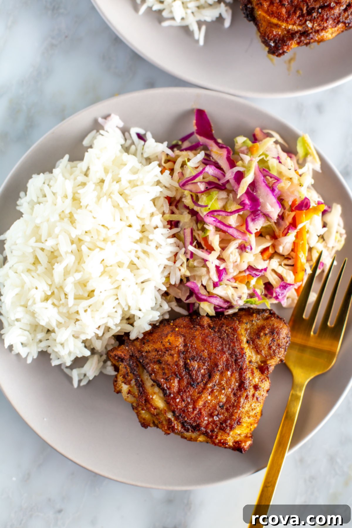 Effortless & Flavorful: 18 Air Fryer Delights 11 Air fryer chicken thighs with coleslaw and rice on a plate