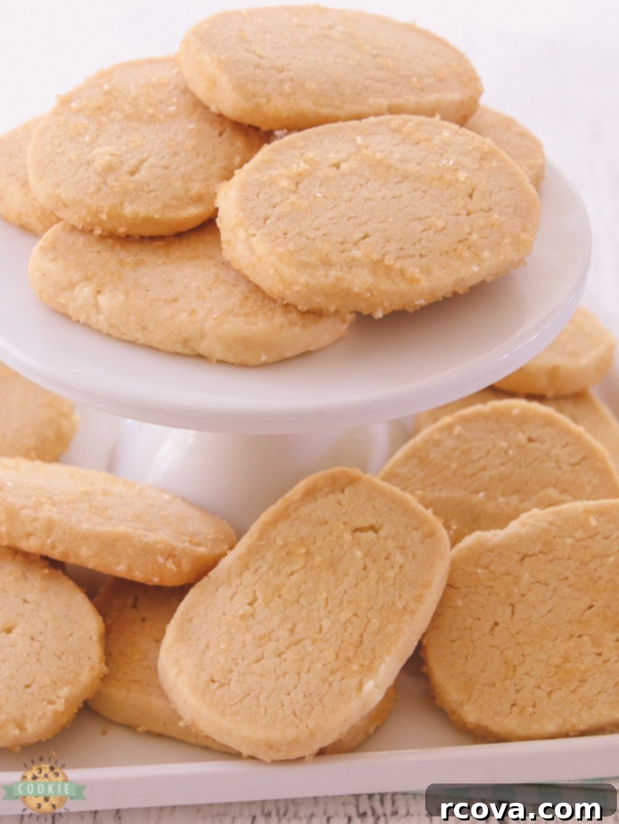 Effortless Vanilla Butter Delights 2 Buttery vanilla slice and bake cookies cooling on a rack, showcasing their golden edges and sugared tops.