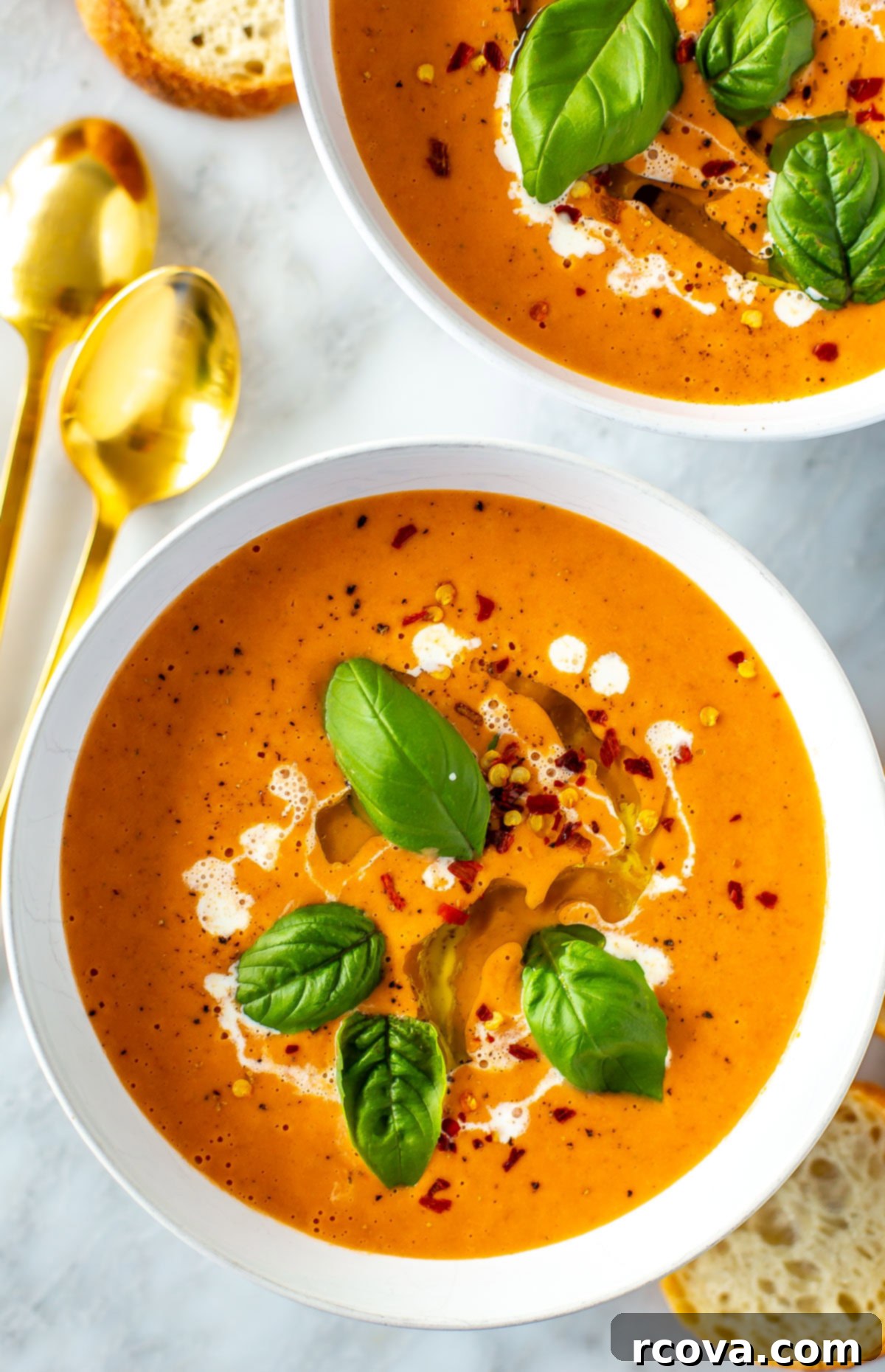 Sun-Kissed Roasted Tomato Basil Bliss 7 A close-up of a rustic ceramic bowl filled with creamy roasted tomato basil soup, garnished with fresh basil leaves and a delicate swirl of heavy cream, ready to be enjoyed.