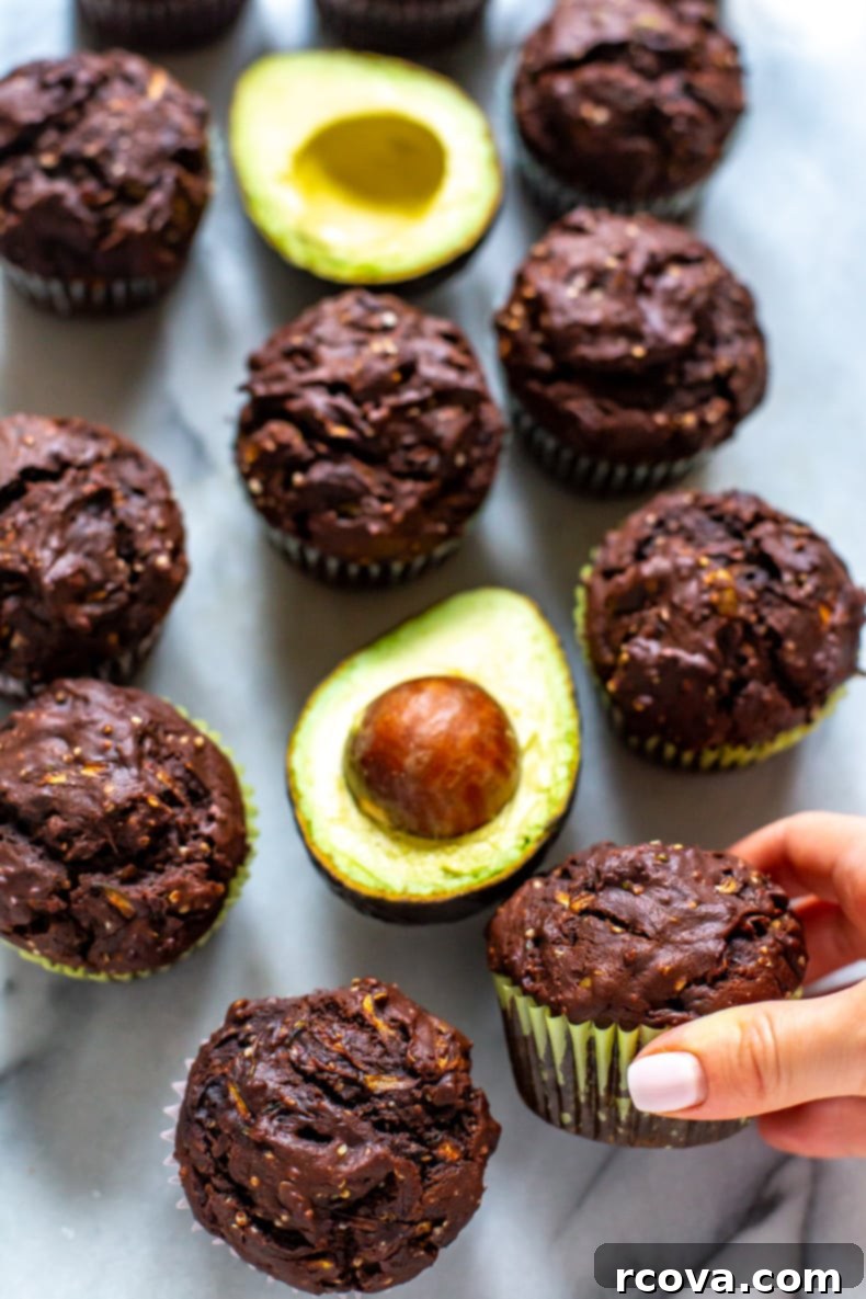 Guilt-Free Double Chocolate Zucchini Muffins 8 Close-up of a stack of Healthy Double Chocolate Zucchini Muffins with Avocado, showing moist texture.