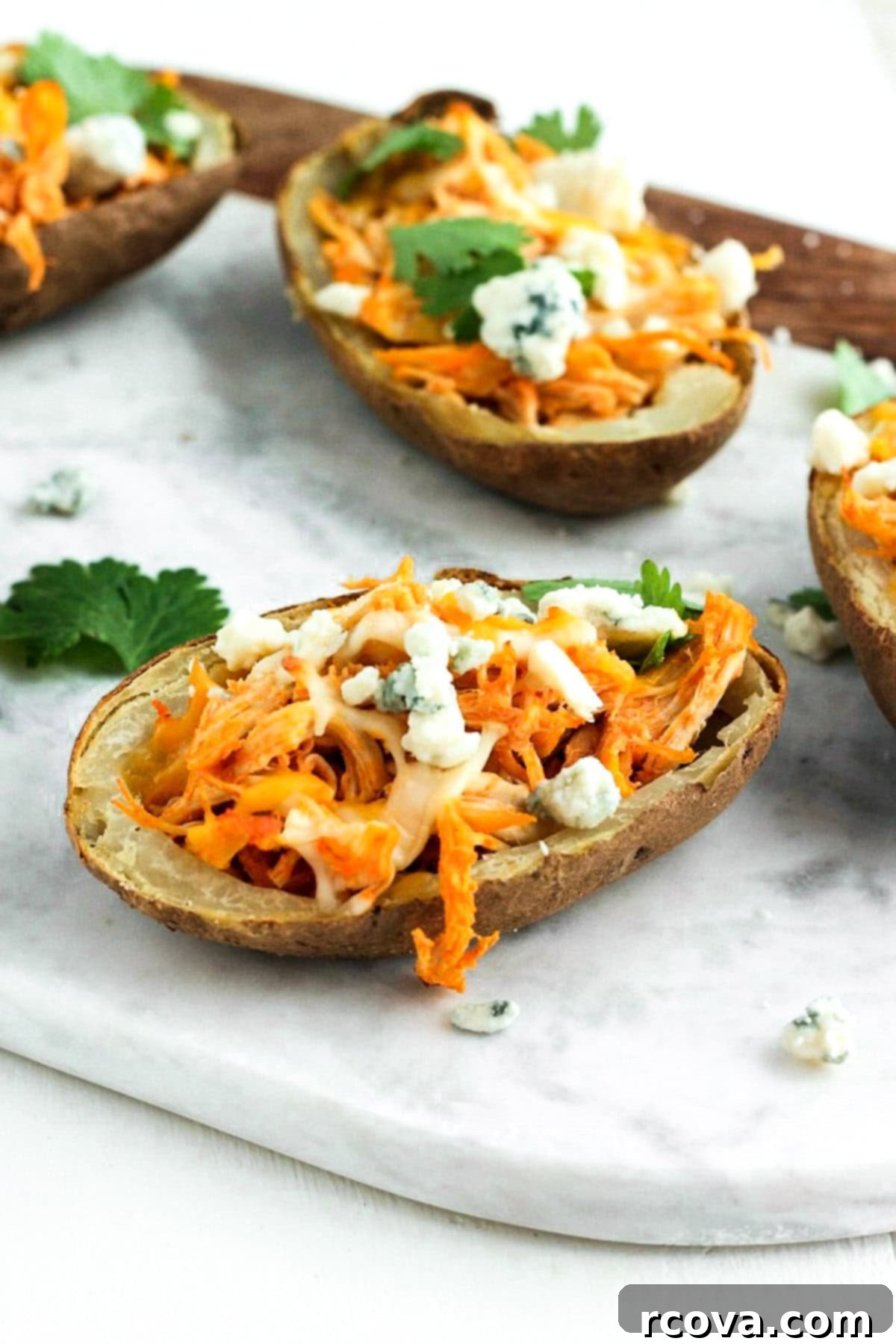 Effortless Make-Ahead Buffalo Chicken Potato Skins 2 Crispy Buffalo Chicken Potato Skins topped with ranch drizzle