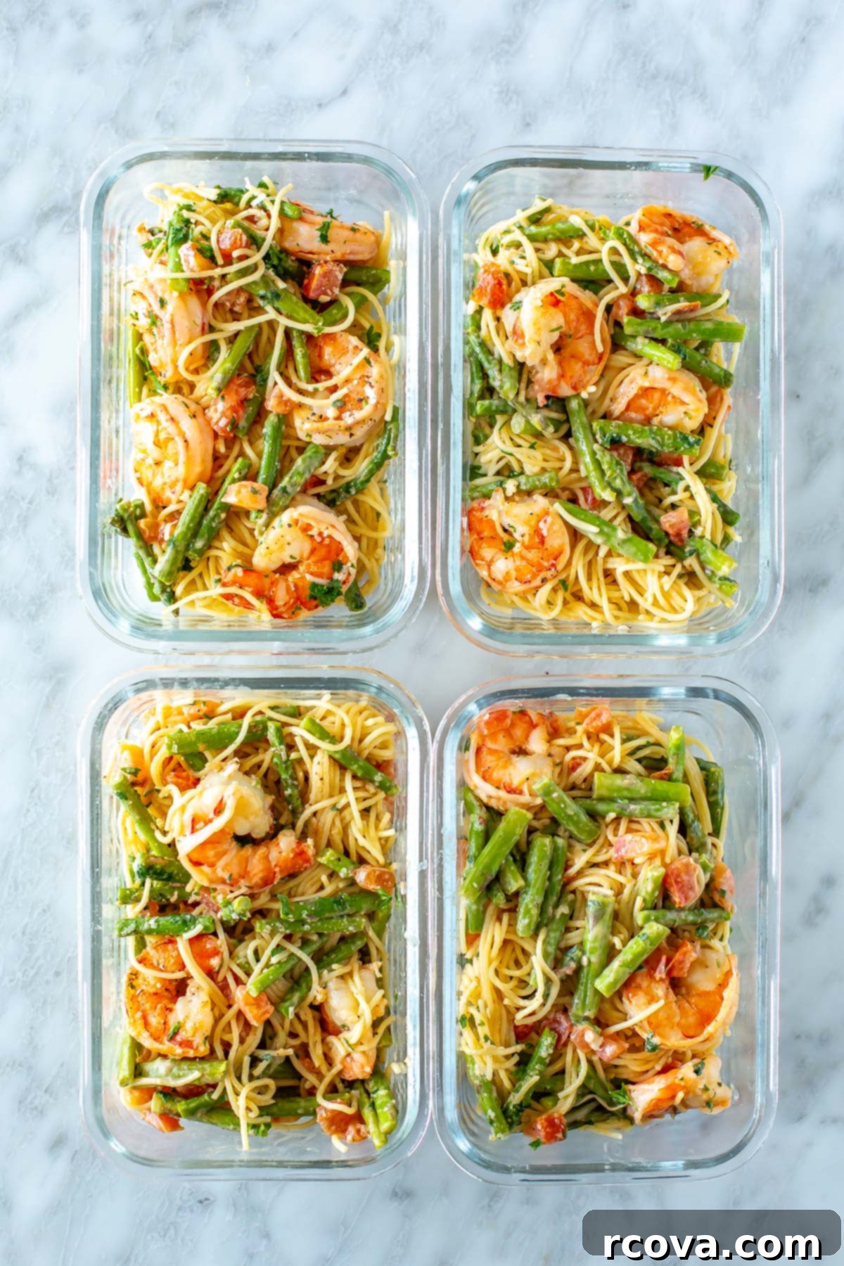 Olive Garden's Shrimp Scampi 10 Four organized meal prep containers, each containing a perfectly portioned serving of homemade Olive Garden Shrimp Scampi, ready for easy weeknight lunches.