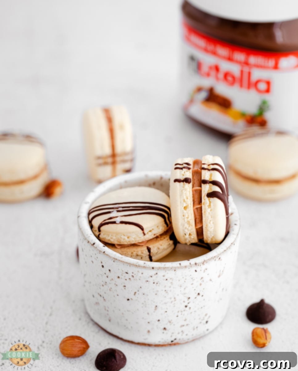 Decadent Nutella Macarons 6 Cooling Nutella Macarons on a baking sheet after baking, showing perfectly formed 'feet'.