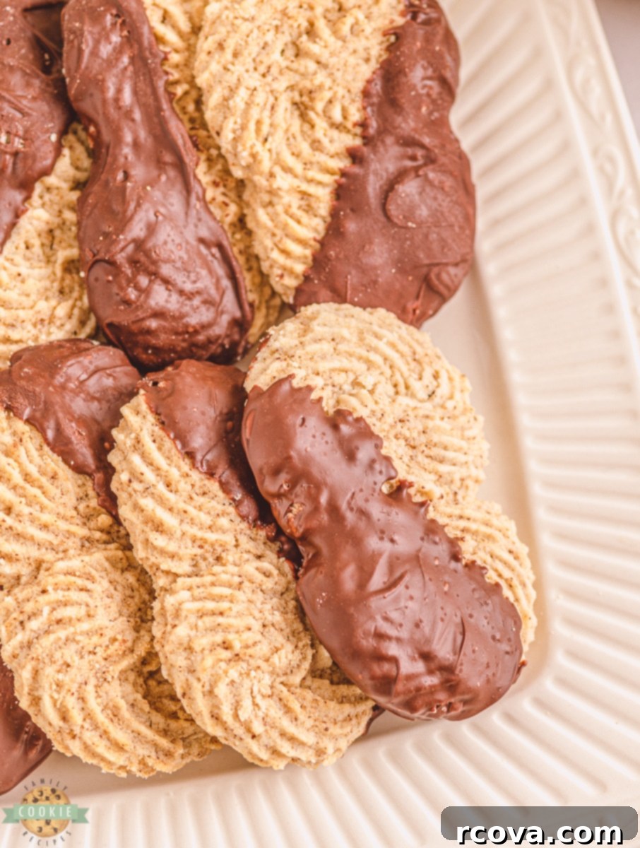 Rich Buttery Espresso Cookies 3 close up of espresso butter cookies on a cooling rack, some dipped in chocolate