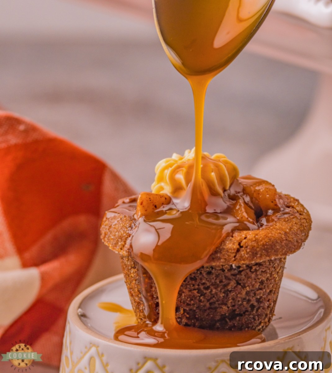 Warm Spiced Caramel Apple Gingerbread Cookies 2 Close-up of a caramel apple gingerbread cookie cup, showcasing the apple filling, gingerbread base, and caramel cream cheese frosting with a caramel drizzle.