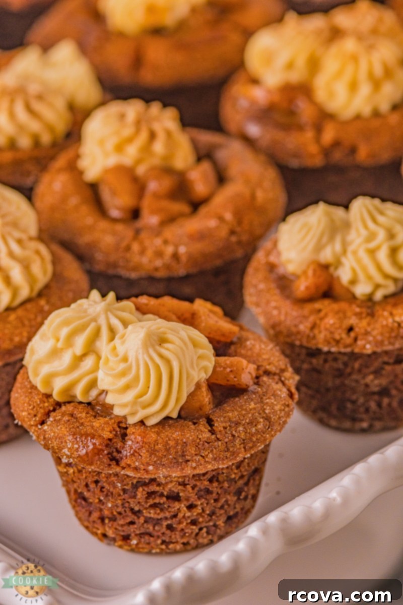 Warm Spiced Caramel Apple Gingerbread Cookies 7 Close-up of baked gingerbread cookie cups cooling in a mini muffin pan, showing the indented centers.